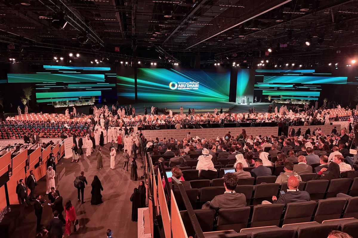 Abu Dhabi Sustainability Week audience filling the hall in front of a wide LED stage